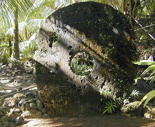 Large carved rai stones with central holes, the stone money of Yap